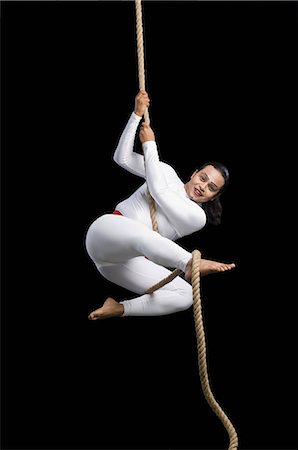 Acrobat performing on a rope Stock Photo - Premium Royalty-Free, Code: 630-03480585