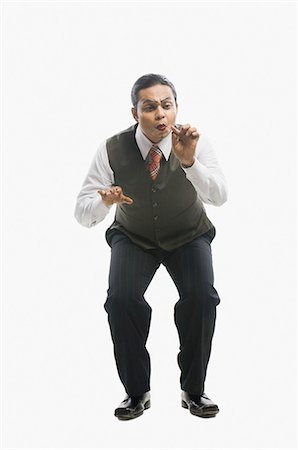 funny indian man - Mime imitating as he is working on computer Stock Photo - Premium Royalty-Free, Code: 630-03480632