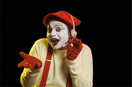 employee hold a sign - Portrait of a mime wearing headset Stock Photo - Premium Royalty-Free, Code: 630-03480702