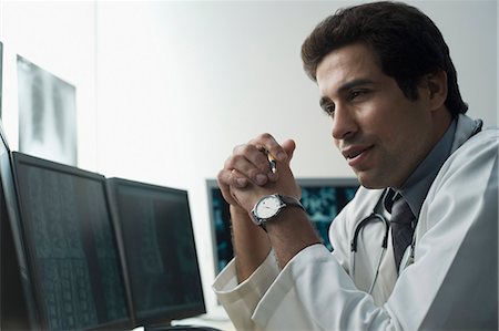 stethoscope check up indian photos - Close-up of a male doctor thinking Stock Photo - Premium Royalty-Free, Code: 630-03480738