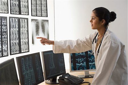 simsearch:625-02931429,k - Female doctor examining an X-Ray report Stock Photo - Premium Royalty-Free, Code: 630-03480749