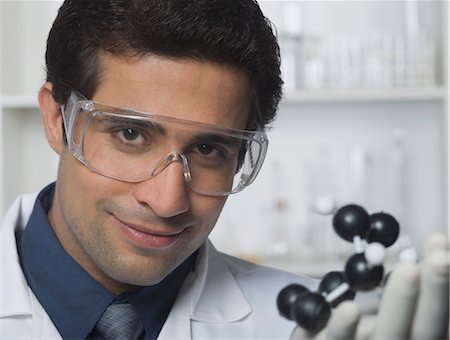 Scientist holding molecular model in a laboratory Stock Photo - Premium Royalty-Free, Code: 630-03480782