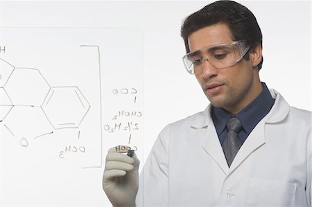 Scientist writing chemical formula Foto de stock - Sin royalties Premium, Código: 630-03480808