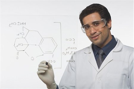 Scientist writing chemical formula Stock Photo - Premium Royalty-Free, Code: 630-03480809