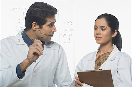 physics - Scientists at work on a problem Stock Photo - Premium Royalty-Free, Code: 630-03480820