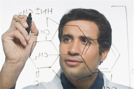 Scientist writing chemical formula Foto de stock - Sin royalties Premium, Código: 630-03480821