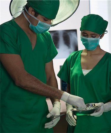 simsearch:649-09078375,k - Surgeons performing surgery in an operating room Stock Photo - Premium Royalty-Free, Code: 630-03480831