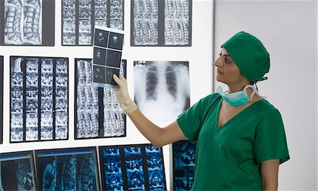 doctor looking at xray - Female doctor examining X-Ray report Stock Photo - Premium Royalty-Free, Code: 630-03481004