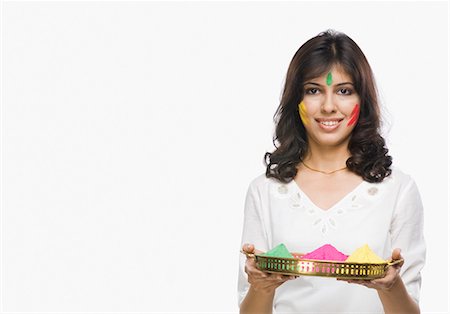 Portrait of a woman holding a plate of powder paint Stock Photo - Premium Royalty-Free, Code: 630-03481040
