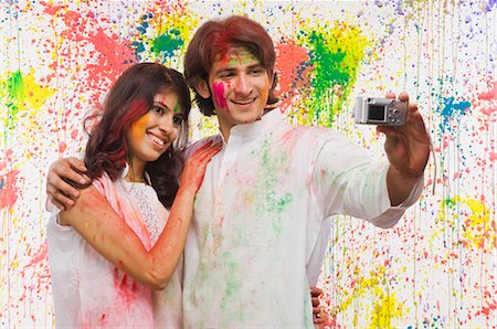 Couple taking a photograph of themselves with a digital camera Stock Photo - Premium Royalty-Free, Code: 630-03481058