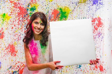 religious portraits - Woman holding a blank placard and smiling Stock Photo - Premium Royalty-Free, Code: 630-03481070