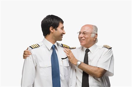 Close-up of two pilots standing together and smiling Stock Photo - Premium Royalty-Free, Code: 630-03481104