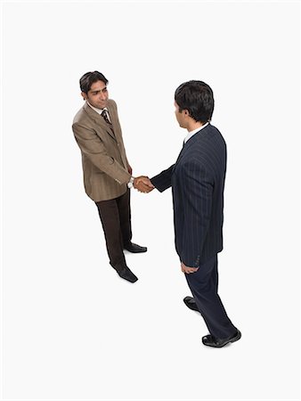 east indian businessman white background - Two businessmen shaking hands Stock Photo - Premium Royalty-Free, Code: 630-03481137