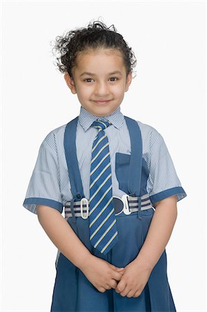 Portrait of a schoolgirl wearing school uniform and smiling Stock Photo - Premium Royalty-Free, Code: 630-03481140
