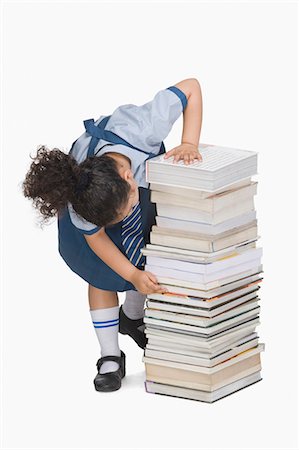 simsearch:640-05761270,k - Schoolgirl counting books in a stack Stock Photo - Premium Royalty-Free, Code: 630-03481173
