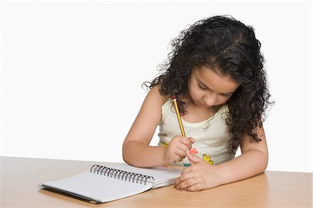 simsearch:630-03481154,k - Close-up of a girl writing in a notebook Foto de stock - Sin royalties Premium, Código: 630-03481189