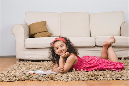 someone laying down with their feet up - Portrait of a girl lying with a notebook and colored pencils Stock Photo - Premium Royalty-Free, Code: 630-03481208