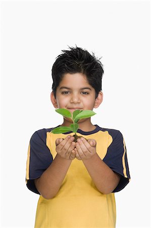 simsearch:632-05759978,k - Portrait of a boy holding a plant Stock Photo - Premium Royalty-Free, Code: 630-03481275