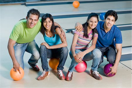 simsearch:630-03481611,k - Two young couples with bowling balls in a bowling alley Stock Photo - Premium Royalty-Free, Code: 630-03481607