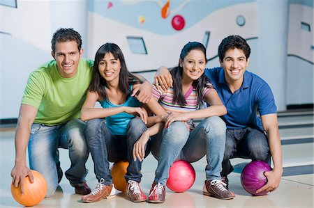 simsearch:630-03481569,k - Two young couples with bowling balls in a bowling alley Stock Photo - Premium Royalty-Free, Code: 630-03481609