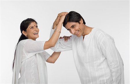 Man putting a woman's hand on his head Stock Photo - Premium Royalty-Free, Code: 630-03481969
