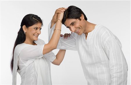 Man putting a woman's hand on his head Stock Photo - Premium Royalty-Free, Code: 630-03481971