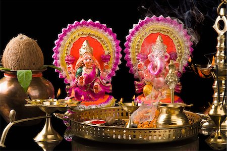 smoke on black background - Diwali thali in front of idols of Lord Ganesha and Goddess Lakshmi Stock Photo - Premium Royalty-Free, Code: 630-03482069