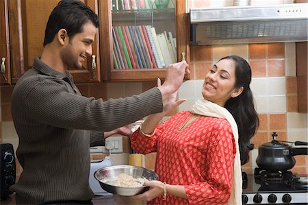 people in india home - Couple having fun in the kitchen while cooking Stock Photo - Premium Royalty-Free, Code: 630-03482612