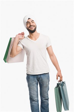 retail white background - Man carrying shopping bags and smiling Stock Photo - Premium Royalty-Free, Code: 630-03482754