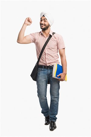 University student holding a book and smiling Stock Photo - Premium Royalty-Free, Code: 630-03482764