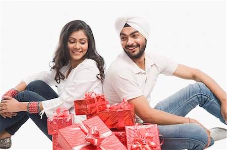 picture of man with red bow - Couple sitting with gifts Stock Photo - Premium Royalty-Free, Code: 630-03482771