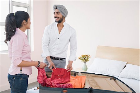 smiling indian mustache - Couple packing a suitcase Stock Photo - Premium Royalty-Free, Code: 630-03482824