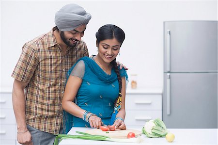 smiling indian mustache - Couple chopping vegetables in the kitchen Stock Photo - Premium Royalty-Free, Code: 630-03482853