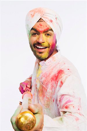 smiling indian mustache - Portrait of a man playing Holi with a pichkari Stock Photo - Premium Royalty-Free, Code: 630-03482915