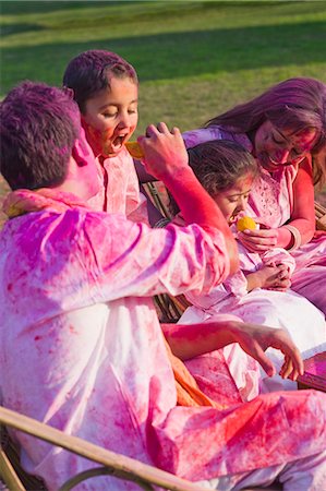 father son dessert - Family celebrating Holi with traditional Indian cuisines Stock Photo - Premium Royalty-Free, Code: 630-03483060