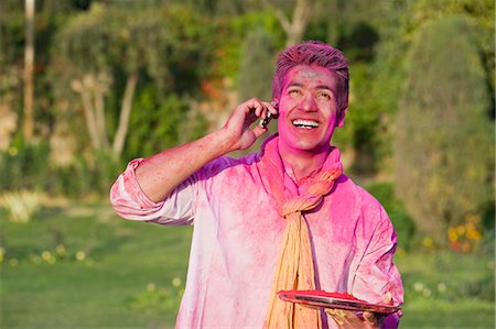 speaking on the phone india - Man celebrating Holi and using a mobile phone Stock Photo - Premium Royalty-Free, Code: 630-03483118