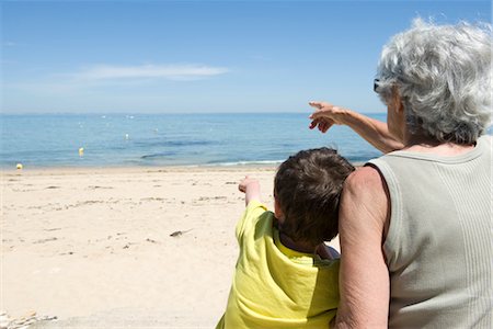 simsearch:696-03401990,k - Grandmother and grandson sitting together on beach, looking at sea Stock Photo - Premium Royalty-Free, Code: 632-05400956