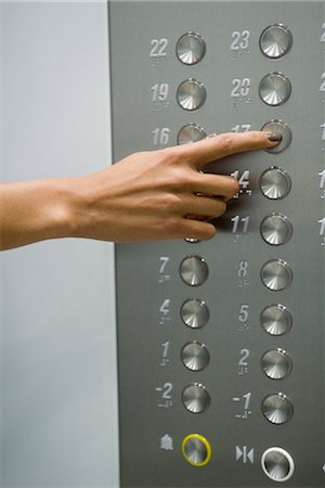 Woman's hand pressing 17 floor button Stock Photo - Premium Royalty-Free, Code: 632-05401000