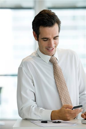 simsearch:632-06118662,k - Businessman text messaging Stock Photo - Premium Royalty-Free, Code: 632-05401097