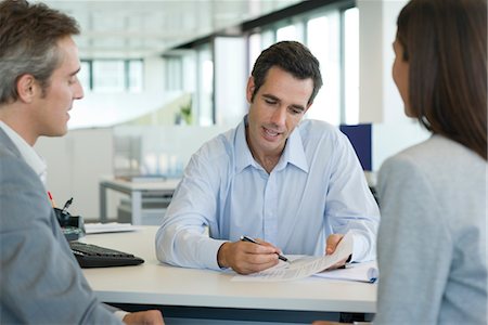 financial advisor talking with clients - Businessman explaining document to clients Stock Photo - Premium Royalty-Free, Code: 632-05401129