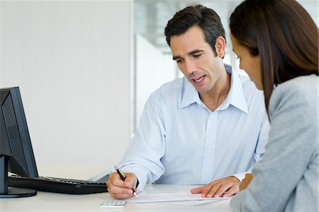 Financial advisor explaining document to client Stock Photo - Premium Royalty-Free, Code: 632-05401153