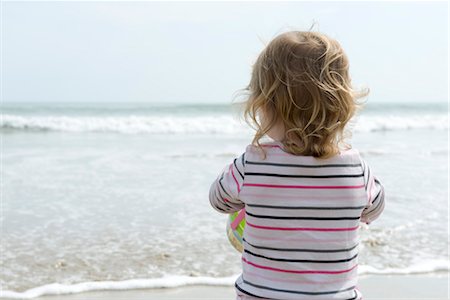 summer beach break - Toddler at the beach, looking at ocean, rear view Stock Photo - Premium Royalty-Free, Code: 632-05401178