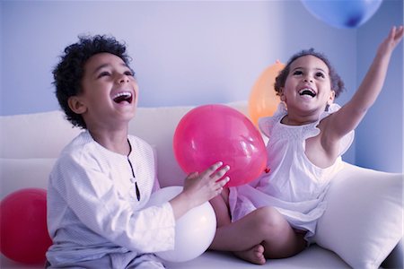 Young brother and sister playing with balloons Stock Photo - Premium Royalty-Free, Code: 632-05401259