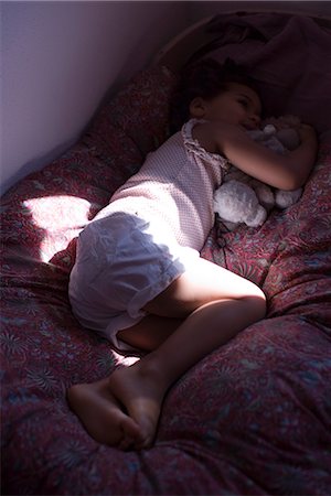 Woman lying down in bed stock photo