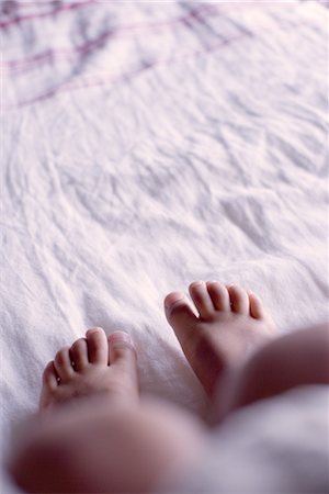 Foot of child on bed, low section Stock Photo - Premium Royalty-Free, Code: 632-05401313