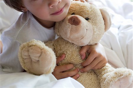 stuffed animal - Little boy hugging teddy bear, cropped Stock Photo - Premium Royalty-Free, Code: 632-05554039