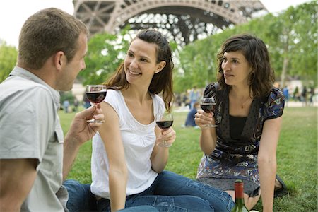 female friends sitting on ground - Friends enjoying wine at picnic near Eiffel Tower, Paris, France Stock Photo - Premium Royalty-Free, Code: 632-05554071