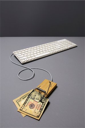 Dollar bill in mousetrap connected to keyboard Stock Photo - Premium Royalty-Free, Code: 632-05554144