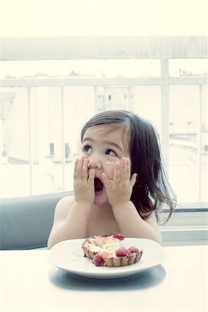 shocked eating - Little girl with surprised expression, hands on cheeks Stock Photo - Premium Royalty-Free, Code: 632-05554159