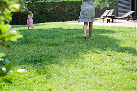 family backyard relaxing - Mother and daughter walking in backyard Stock Photo - Premium Royalty-Free, Code: 632-05554151